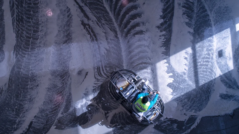 Overhead view of an operator mechanically preparing a concrete floor.